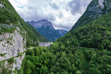 Alpine landscape with green forest in Predil Pass, Italy. Aerial drone view