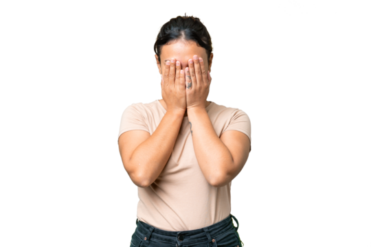 Young Uruguayan woman over isolated chroma key background covering eyes by hands