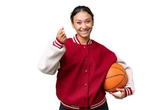 Young Uruguayan woman playing basketball over isolated wall  over isolated chroma key background shaking hands for closing a good deal