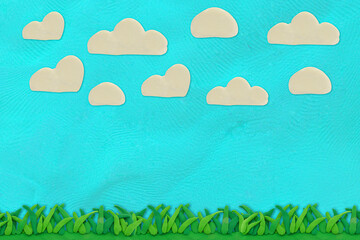 green grass and blue sky with cloud made from plasticine art