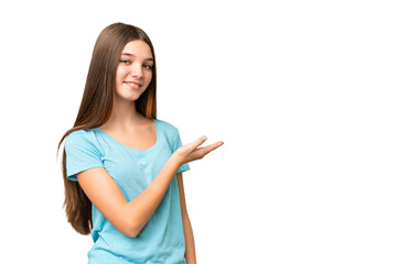 Teenager girl over isolated chroma key background presenting an idea while looking smiling towards