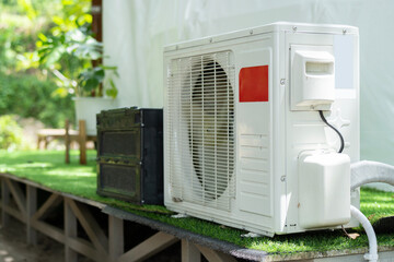Air conditioner compressor outdoor unit installed outside the geodesic dome tent for camping in...
