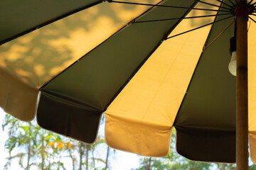 Croppe image of vintage two tone color fabric texture of umbrella for background.