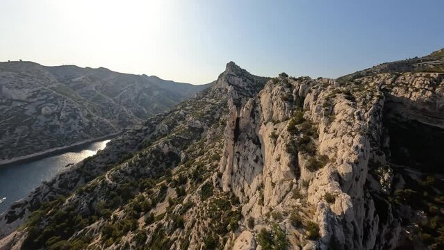 FPV race drone aerial video of flights over the cliffs of a calanque or calanche landform.