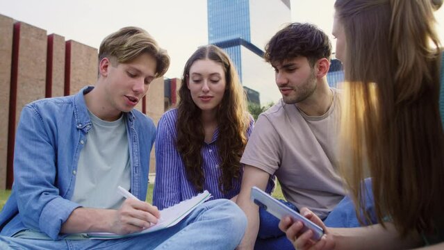 Group of caucasian students studying outside the university campus. Shot with RED helium camera in 8K.  
