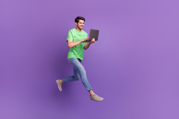 Fototapeta na wymiar Full body cadre of jumping professional it specialist program developer running deadlines use laptop isolated on violet color background