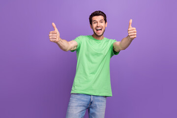 Portrait of funny positive ecstatic guy with bristle wear green t-shirt showing thumbs up good job...