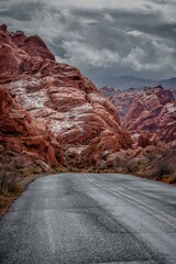 Desert Serenity: Panoramic View of an Empty Road Surrounded by Red Rock Canyon After a Storm, Presented in Captivating 4K Resolution