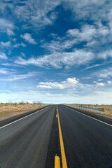 Desert Serenity: Panoramic View of an Empty Road Surrounded by Red Rock Canyon After a Storm,...