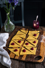 Woman making traditional Ukrainian baked goods --  crescents with edible rose jam.