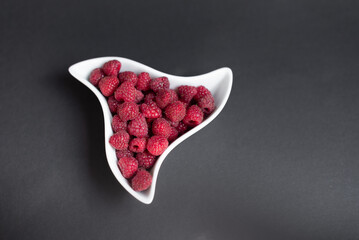 Sweet fresh organic raspberries background close-up. Fresh and sweet raspberries background