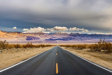 Desert Serenity: Panoramic View of an Empty Road Surrounded by Red Rock Canyon After a Storm, Presented in Captivating 4K Resolution