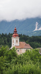 Beautiful alpine church of a slovenian village on a cloudy day