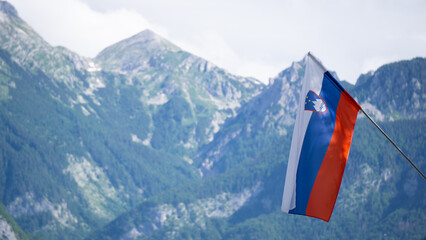 Slovenia‘s flag with the Alps in the background 