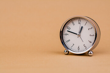 Alarm clock. Beautiful modern clock lies on paper background. time clock time standstill time off...
