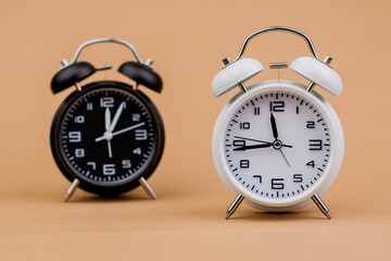 Alarm clock. Beautiful modern clock lies on paper background. time clock time standstill time off...
