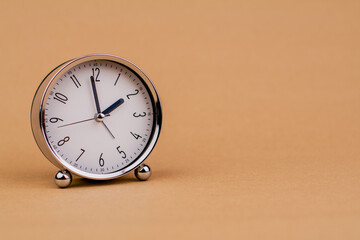 Alarm clock. Beautiful modern clock lies on paper background. time clock time standstill time off...