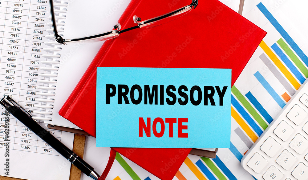 Aufkleber promissory note text on a sticky on red notebook on chart background