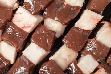Liver skewer. Close-up raw liver shish kebab. Food background.Turkish cuisine delicacies. Local name ciger sis