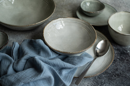 Close-up of assorted ceramic plates and bowls on a table