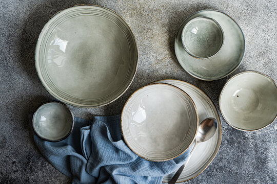 Overhead view of assorted ceramic plates and bowls on a table