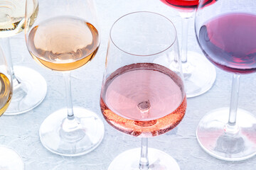 Wine glasses at a tasting. Rose, red, and white wine, drinks on a table