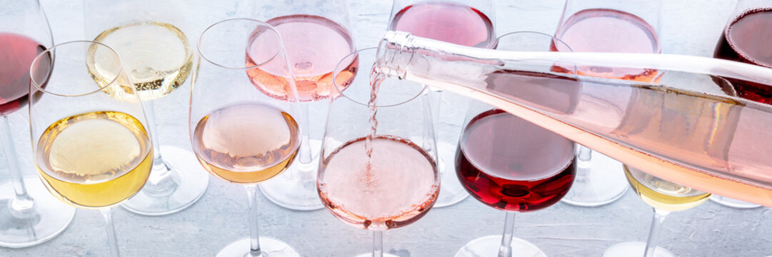 Rose wine poured into a glass at a tasting panorama. Rose, red, and white wine