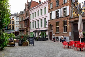 Fotobehang Old street with tables of cafe in historic city center of Antwerpen (Antwerp), Belgium. Cozy cityscape of Antwerp. Architecture and landmark of Antwerpen © Ekaterina Belova