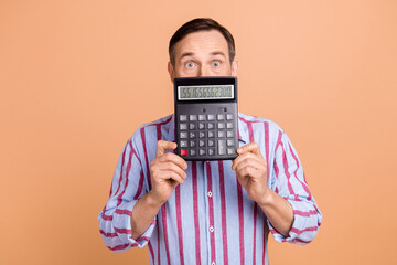 Photo of impressed senior man hands hold calculator cover half face huge debt numbers isolated on...