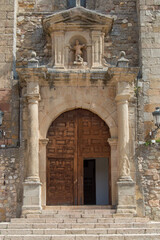 Fototapeta na wymiar wooden door with arch, columns and stone sculpture in the church of san Juan Bautista in Atienza, province of Guadalajara. Spain
