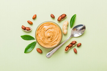 Bowl of peanut butter and peanuts on table background. top view with copy space. Creamy peanut pasta in small bowl