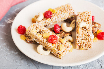 Various granola bars on table background. Cereal granola bars. Superfood breakfast bars with oats, nuts and berries, close up. Superfood concept