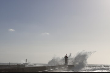 Fototapeta na wymiar Lighthouse by the shore of Porto, Portugal