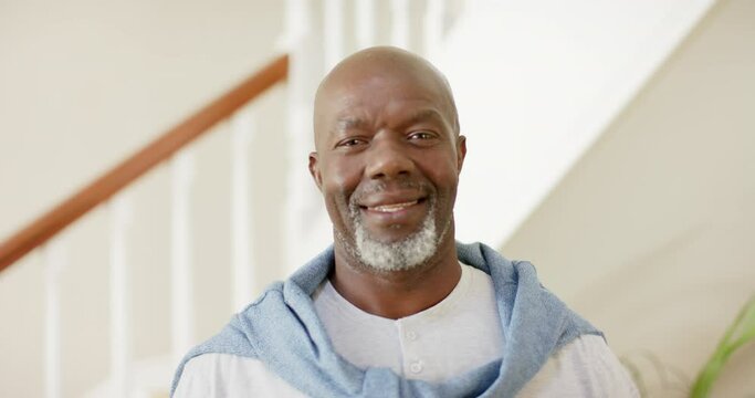 Portrait of happy african american senior man at home, slow motion