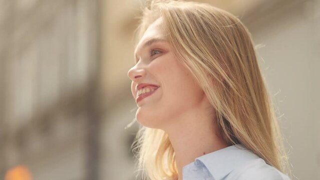 Close up portrait of smiling carefree young blond woman feeling absolutely happy and satisfied enjoying great day at city street Self confidence female looking ahead feel proud achievement alone