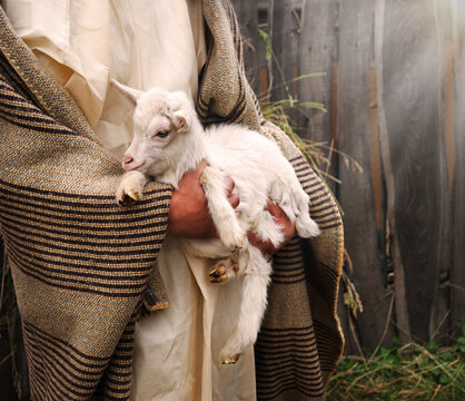 Shepherd with a sheep in his arms