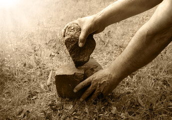 Hands of primitive man with stone