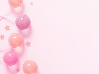Cute frame with pink and orangey-pink candy bars and small stars scattered on a pink background.