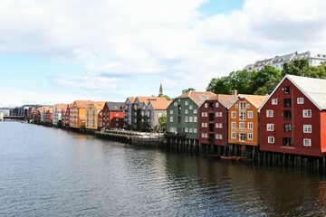 Fototapeta premium Colorful buildings line the canal running through Trondheim, Norway
