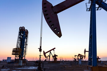 In the evening, oil pumps are running, Silhouette of beam pumping unit