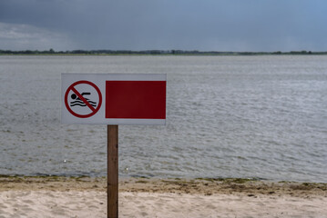 NO SWIMMING - Warning sign on shore of the lake