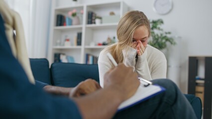 Crying woman talking to psychologist, psychotherapy session, victim of violence