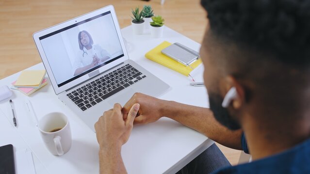 African American man having online consultation with doctor, video call, healthcare