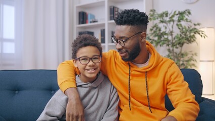 African American father hugging his little son, happy family, parenthood - obrazy, fototapety, plakaty