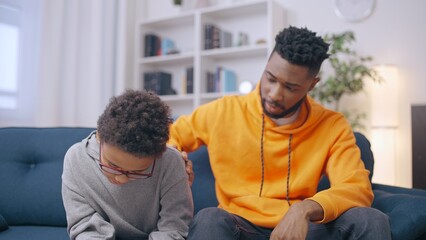 Fototapeta premium Young man comforting his upset little brother, caring relationship, support