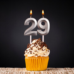 birthday cupcake with number 29 candle - Celebration on dark background