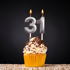 birthday cupcake with number 31 candle - Celebration on dark background