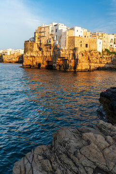 View of the medieval village of Polignano a Mare on top of the cliff at sunset, Bari, Apulia, Adriatic Sea Sea