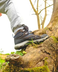 Man wearing outdoor shoes in the nature, climbing and trekking theme