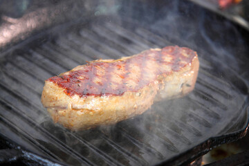 Steak. Preparation of steak on the grate.